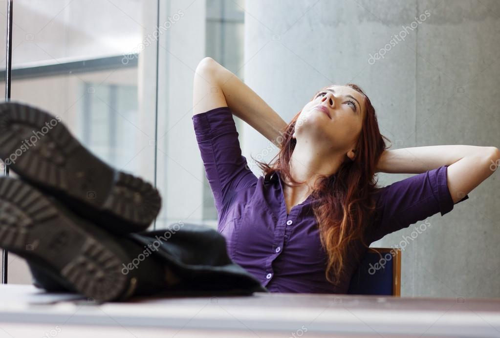 Businesswoman Feet Up Gazing At The Ceiling Stock Photo