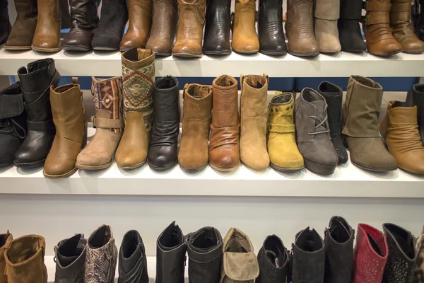 Boots display on white shelf — Stock Photo, Image