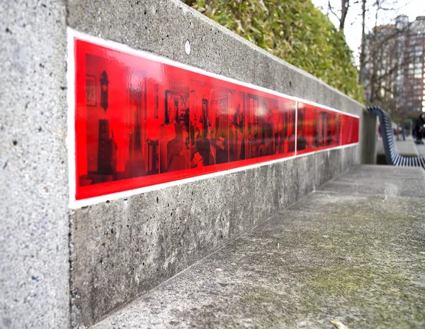 Red strip posting on cement wall — Stock Photo, Image