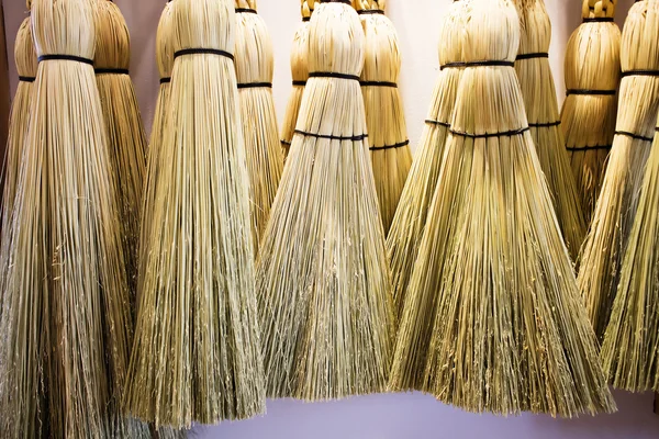 Brooms hanging on wall — Stock Photo, Image
