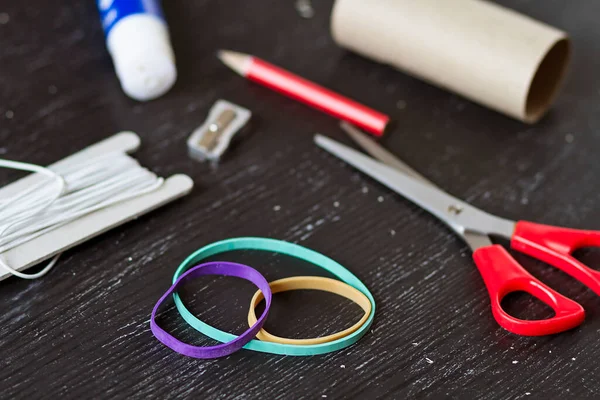 Elastic bands and homemade tools for crafting and homework