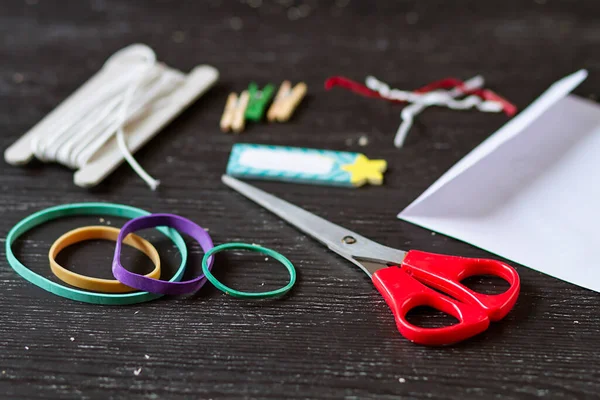 Elastic bands and homemade tools for crafting and homework