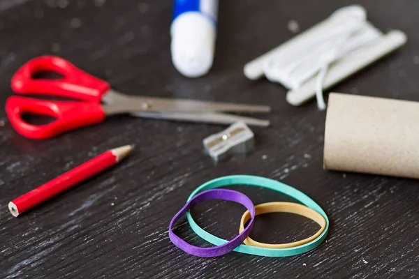 Elastic bands and homemade tools for crafting and homework