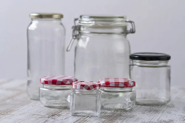 Empty glass jars of different sizes and shapes