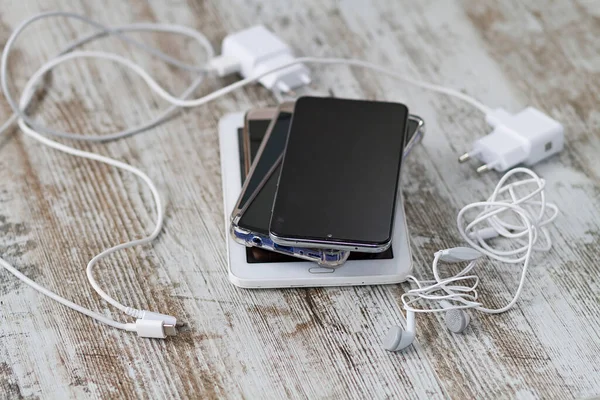 A smartphone battery and its charging and audio cables
