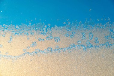 Snow structure on a skylight with blue sky ice crystals