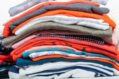 Giysiler gardıropta farklı renklerde dizilmiş.