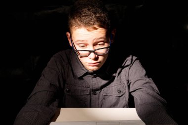 Çocuk dizüstü bilgisayarında gözlüklerle çok gergin.