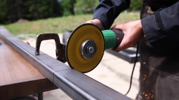 A women welding iron with a disc shaped grinder — Stock Video