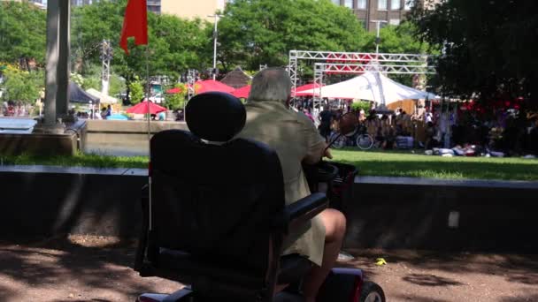 Short Movie Shot Back Elderly Man Sitting Mobility Scooter Watching — 图库视频影像