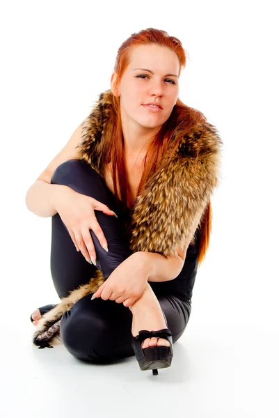 A beautiful red-haired girl posing with fur — Stock Photo, Image