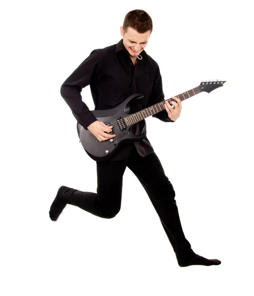 A beautiful boy with electric guitar, jumps — Stock Photo, Image
