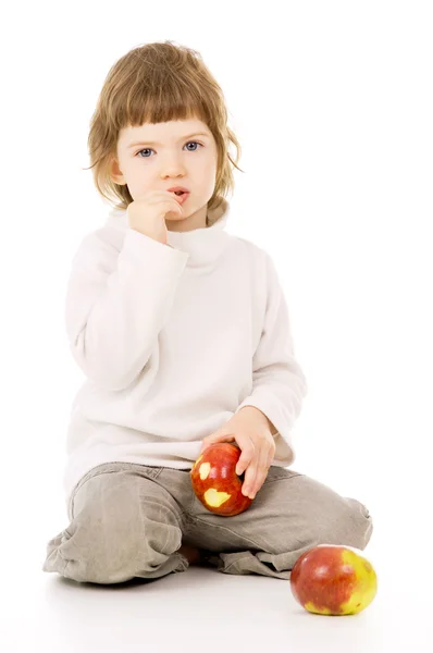 En vacker liten flicka äter äpplen — Stockfoto