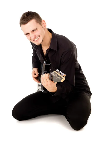 A handsome guy plays the electric guitar — Stock Photo, Image