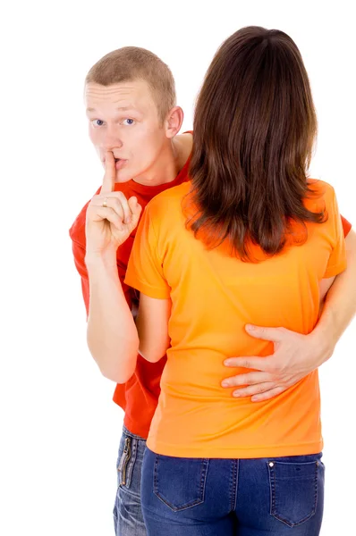 The handsome young man is hugging a girl, and shows silence — Stock Photo, Image