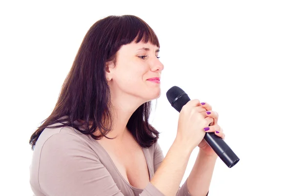 Beautiful girl singing into the microphone — Stok fotoğraf