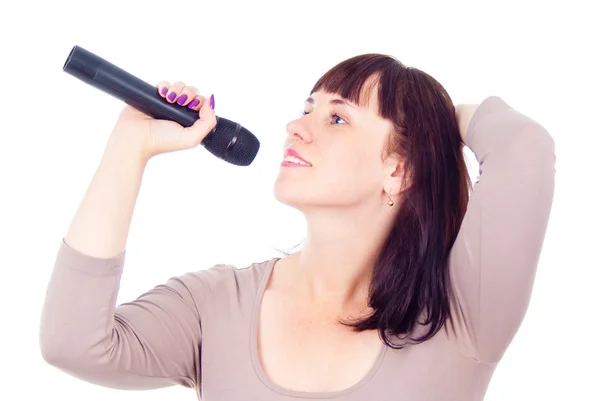 Beautiful girl singing into the microphone — Stok fotoğraf