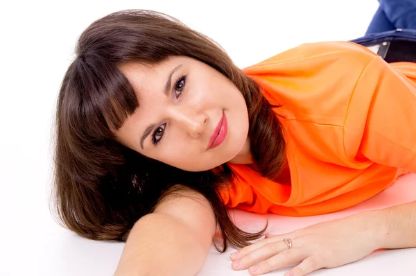 Beautiful girl poses while lying on the floor — Stock Photo, Image