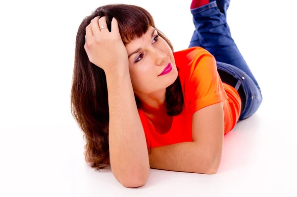 Beautiful girl poses, lying on the floor — Stock Photo, Image