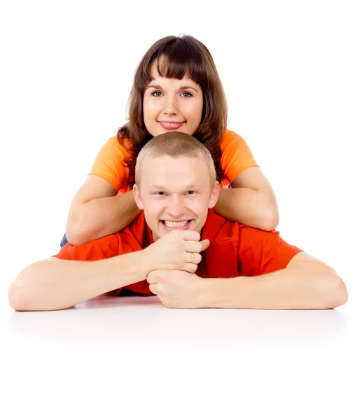 Happy girl lies on his back at the guy on the floor — Stock Photo, Image