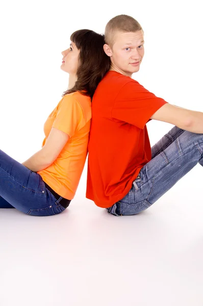 Happy boy and a girl sitting with her, pressed back — Stock Photo, Image