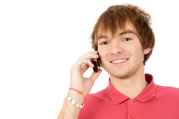 Beautiful guy is standing and talking on a mobile phone — Stock Photo, Image