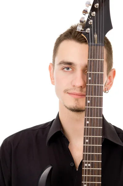 Beautiful guy thinks, pressed to the guitar — Stock Photo, Image