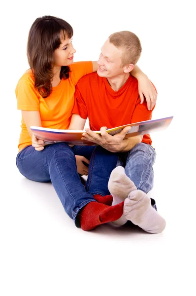 Young family reading a book together — Stock Photo, Image