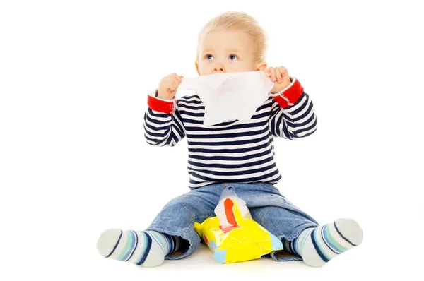 Little baby get wet wipes, and wipes his face Royalty Free Stock Photos