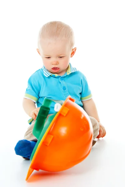 Menino criança com um capacete de construção — Fotografia de Stock