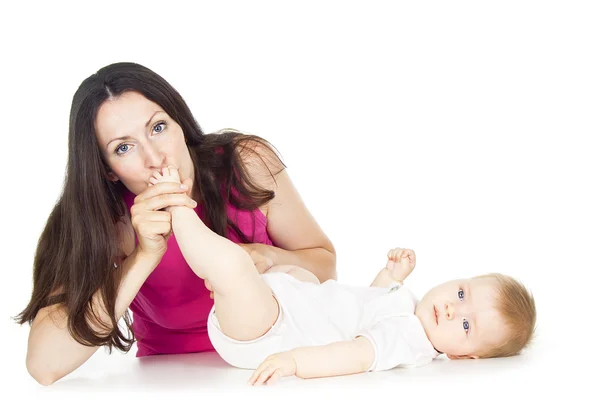 Beautiful mom kissing baby leg — Stock Photo, Image