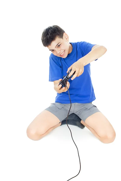 Menino joga no joystick enquanto deitado no chão — Fotografia de Stock