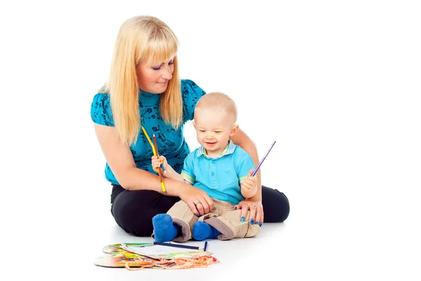 Beautiful mother with a child draws Stock Photo