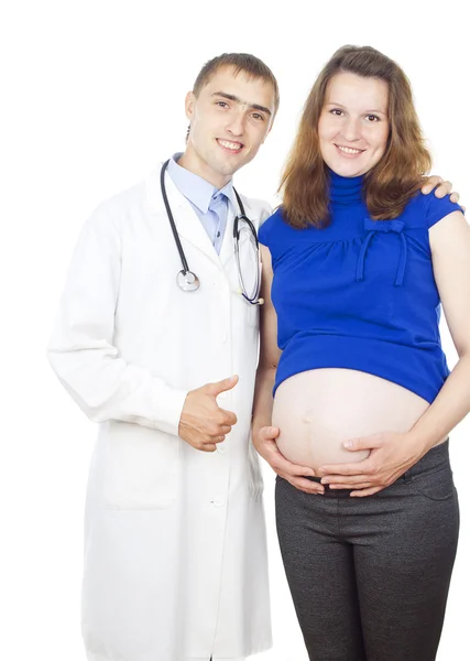 医師は妊娠中の女性の腹部の上を示します — ストック写真