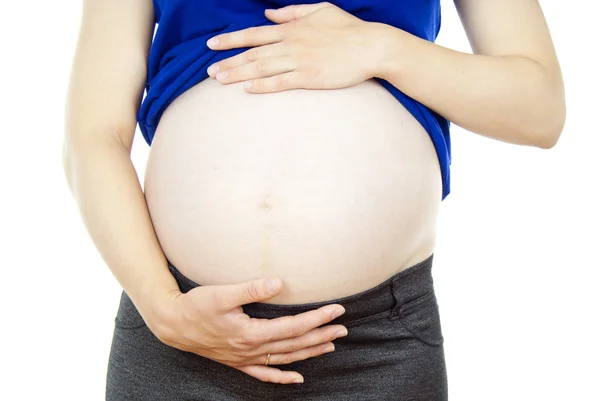 Těhotná žena se dotýká břicha — Stock fotografie