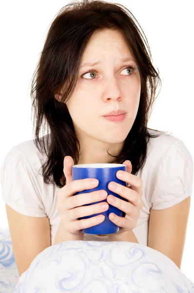 The diseased girl sitting on the bed and drink medicine — Stock Photo, Image