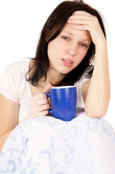 The girl sitting on the bed and a very sore head — Stock Photo, Image