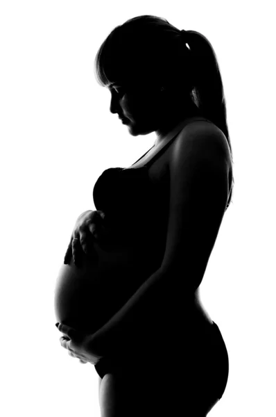 Pregnant girl in underwear in profile Stock Picture