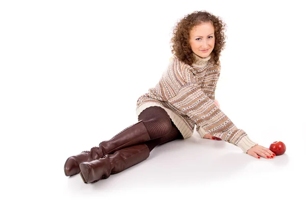 Beautiful girl in a sweater sitting — Stock Photo, Image