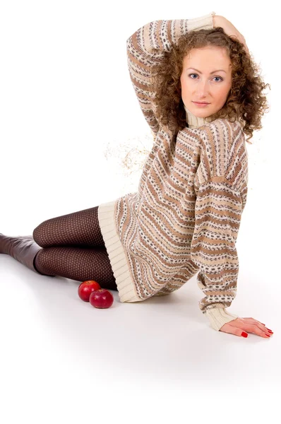 Flickan sitter i en tröja och äpplen — Stockfoto
