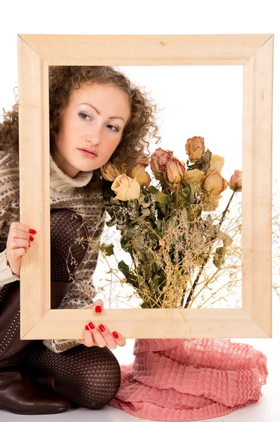 Flicka med ram och ett Stilleben med blommor — Stockfoto