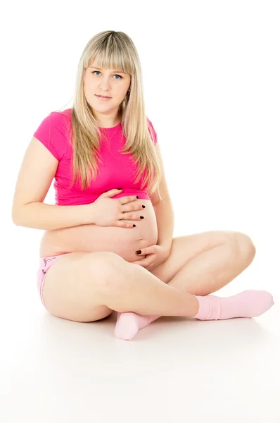 Zwangere meisje zit — Stockfoto