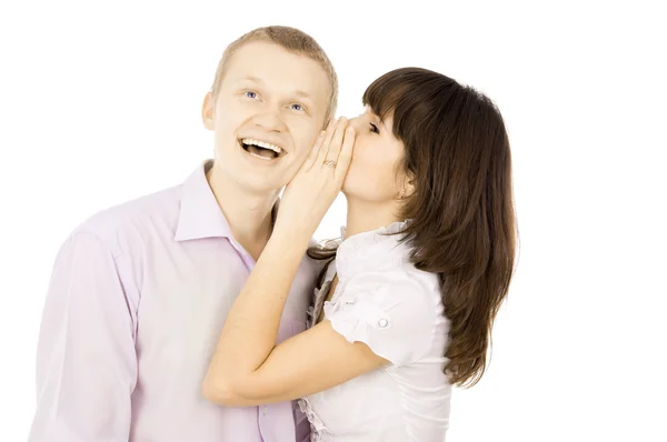 The girl whispers to the guy in the ear — Stockfoto