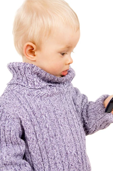 The little boy looks in the mobile phone — Stock Photo, Image