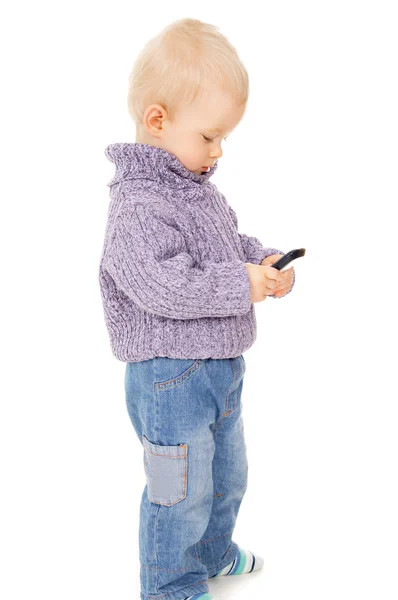 The little boy looks in the mobile phone — Stock Photo, Image