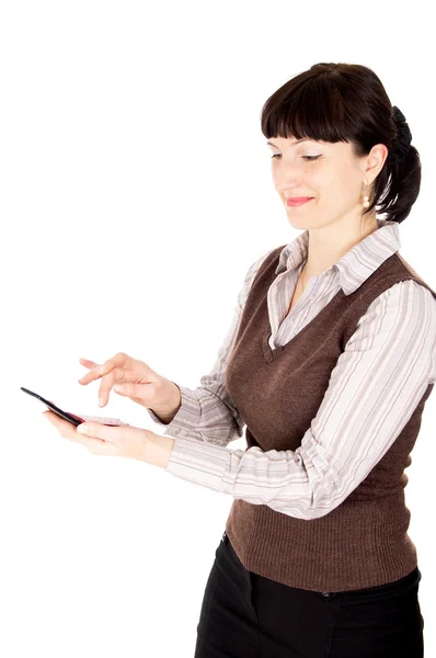 A beautiful young dark-haired woman gains on a mobile phone — Stock Photo, Image