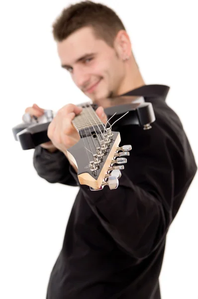 A young guy in a black clothes shows guitar — Stock Photo, Image