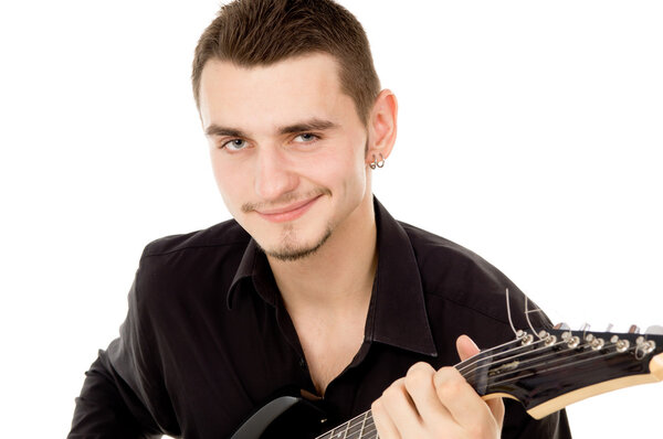 beautiful guy dressed in black clothes sits and plays the guitar
