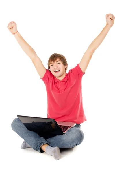 Beautiful guy sitting for the laptop and happy raising a hand in — Stock Photo, Image