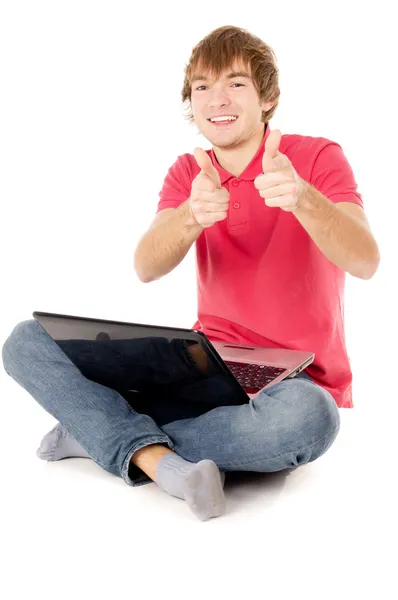 Beautiful guy sitting for the laptop and pointing at you — Stock Photo, Image